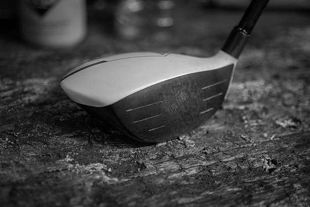 Close-up of a vintage golf club head on a textured surface.